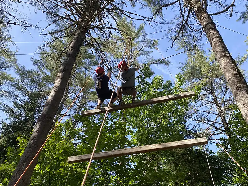 Students repelling on Adventure Bound's ropes course.